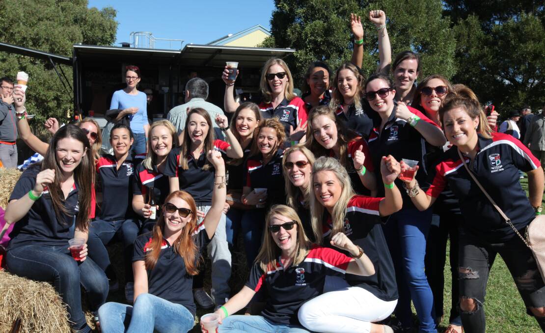 Here for the craic: A group of Irish expats soak up the sunshine at the Koroit Irish Festival before taking part in the Gaelic games.