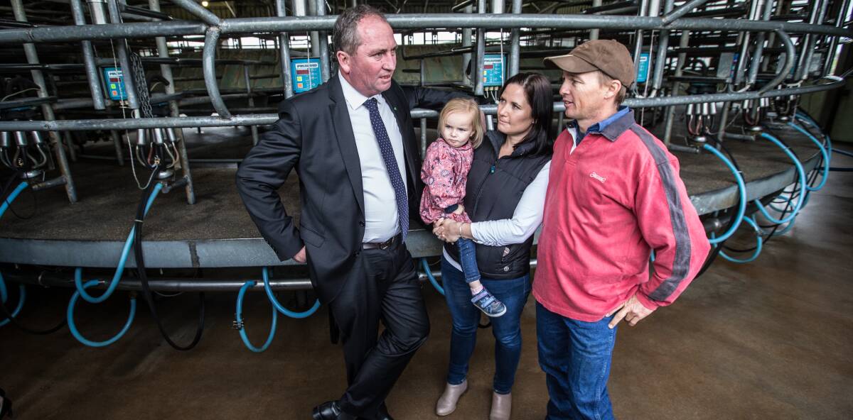 Package pitfalls: Agricultural Minister Barnaby Joyce meeting with dairy farmers Ahsley and Lucy Galt and daughter Alice. 