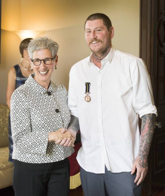 Nathan Beasy is congratulated by Governor of Victoria Linda Dessau. Picture: Norm Oorloff