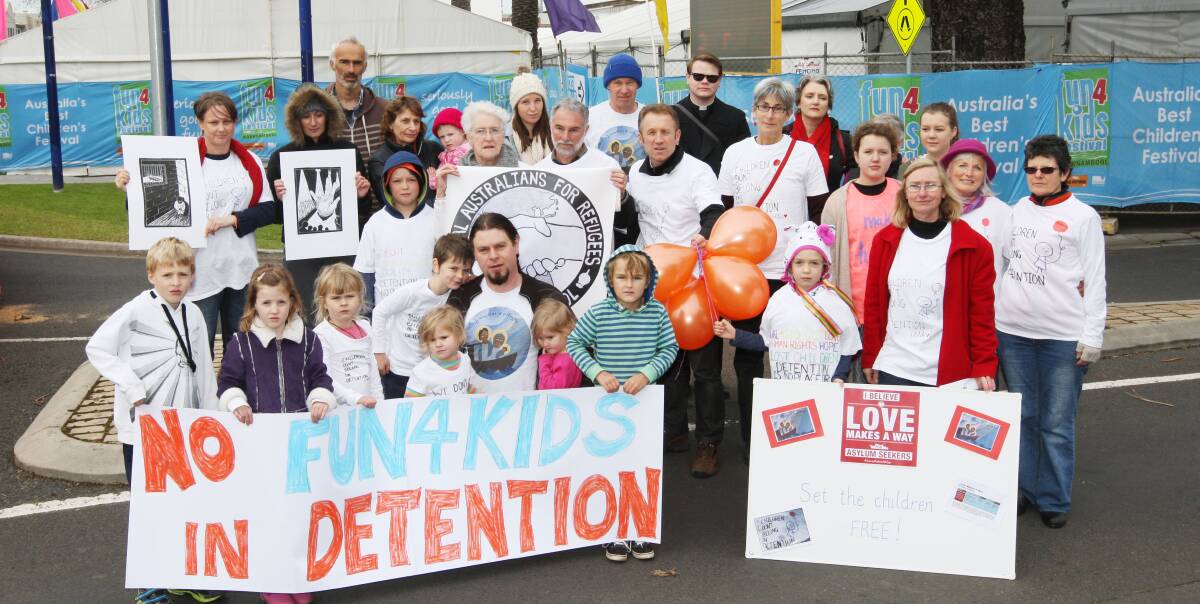 Protest: Refugee advocates from Love Makes a Way and Rural Australians for Refugees draw attention to the plight of children in detention outside Warrnambool's Fun4Kids Festival on Friday. Picture: ANGELA MILNE