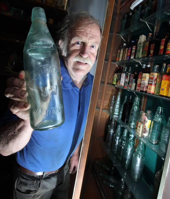 On show: South West Bottle and Collectables Club's Bruce Lowenthal, of Port Fairy, with some of the rare bottles that will go on display at the group's annual show in Warrnambool this weekend.