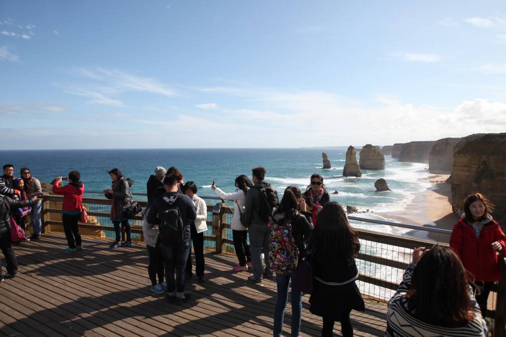 Time to rethink: Tourists take in the view at the iconic Twelve Apostles.