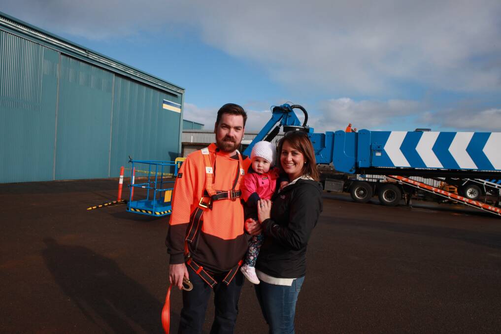 On solid ground: Chris Dowling with wife Alanna and daughter Addison, 1, following his charity ride in the boom lift.