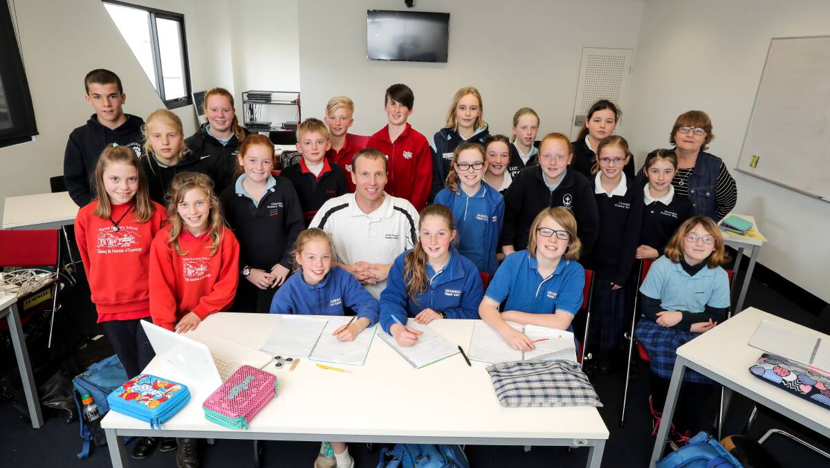 PASSION: Primary school students from around the region get some writing tips from local author Matt Porter and mobile library teacher Christine Howlett at a writing workshop. Picture: Rob Gunstone