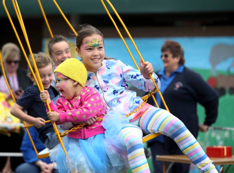 FUN: Kryschelle, 3, and Eyesha Kelly, 9 from Purnim, hang on tight as they spin on one of the rides at the Cobden Spring Festival in 2016. Picture: Amy Paton