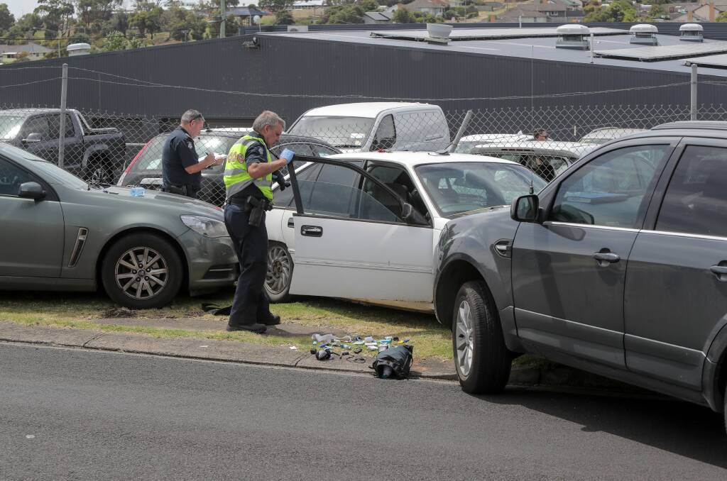 DAMAGE: Police inspect the damage done to two police vehicles. Picture: Rob Gunstone