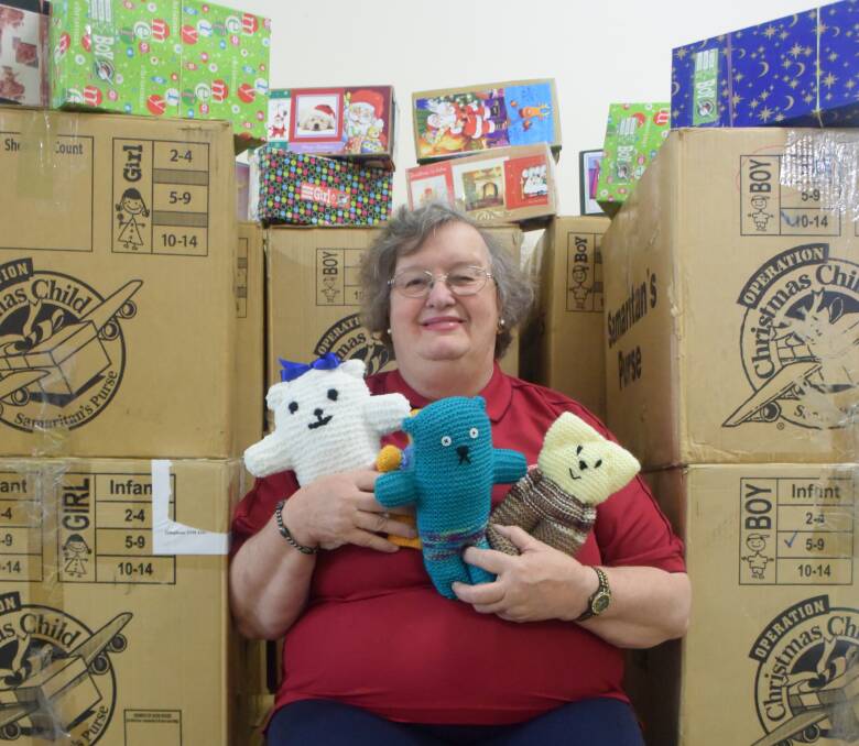 JOY: Lorraine Fitzpatrick takes a break from packing special presents for children in South East Asia. Ms Fitzpatrick and her sister Marilyn Coleman have been behind Operation Christmas Child for 15 years.