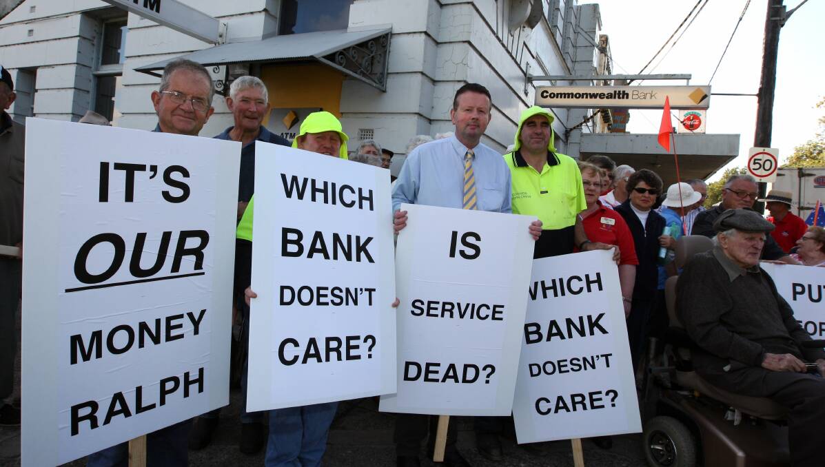 PROTEST: Terang solicitor David Pugh (centre) is calling for the NAB to extend its hours after the Commonwealth Bank announced plans to close their branch in June.
