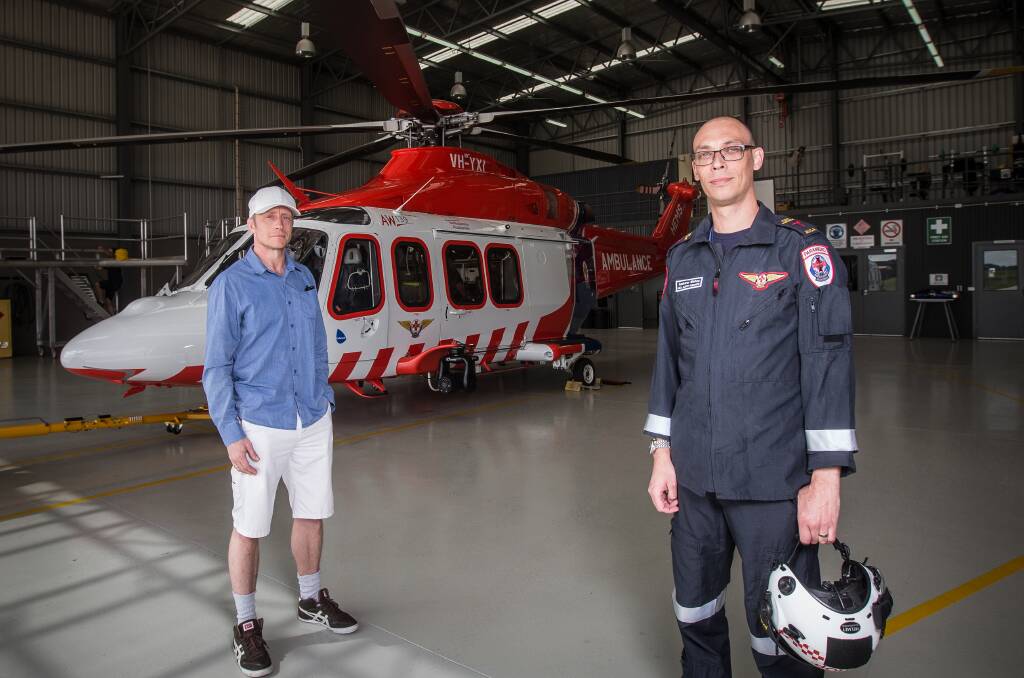 Homecoming: Former exchange student and Norwegian emergency doctor Espen Fevang, saw inside the HEMs 4 air ambulance with MICA flight paramedic Andrew Bishop on Friday. Picture: Christine Ansorge