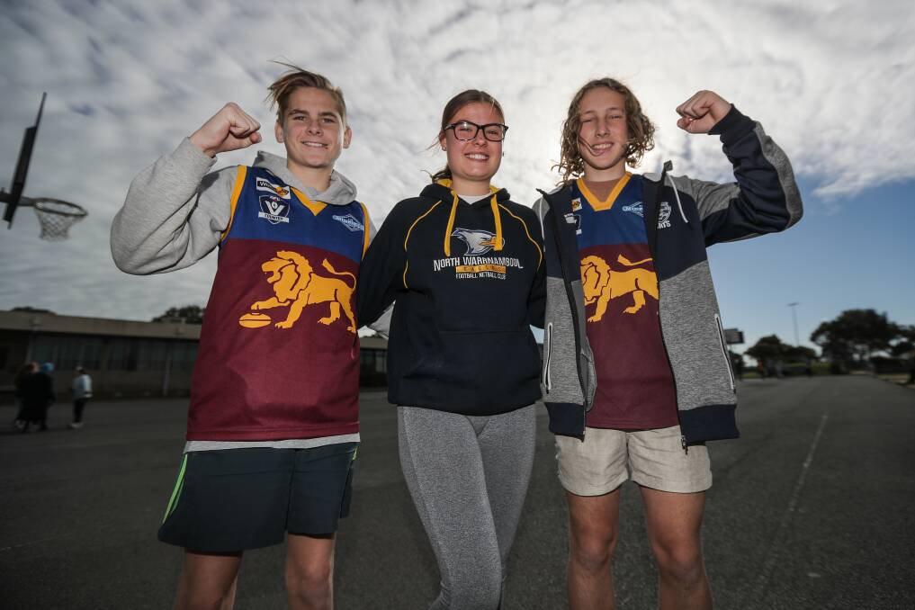 Mates: Brauer College students Kobi Bidmade, 15, Hana Price, 15, and Chad Yates, 14, show off their footy colours while raising money for their friend Luke King who is undergoing treatment for a rare liver disease. Picture: Morgan Hancock