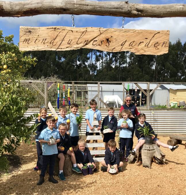 Healthy: Woolsthorpe Primary School country fair co-ordinator Suzi Ireland and students in the mindfulness garden where they will sell apple trees and other items.