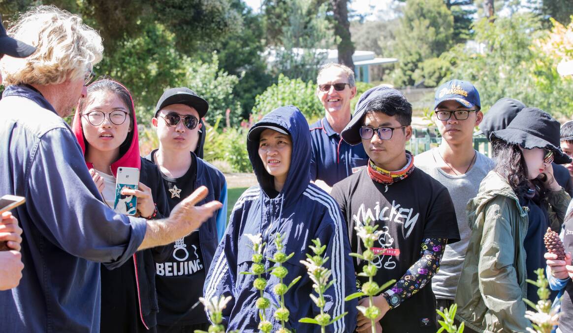 New environment: Warrnambool Botanic Gardens curator John Sheely shows Chinese horticulture students around the gardens as part of their visit. Pictures: Christine Ansorge