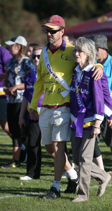 Grateful: Glenn Heazlewood walking with his mother Fay Kelson, who has been cancer free for almost three years. Picture: Amy Paton