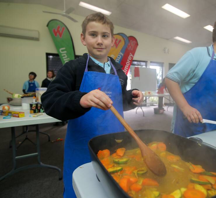 Nash Cuzens, 10, prepares a vegetable curry as part of the school's Kitchen Garden program. Picture: Rob Gunstone