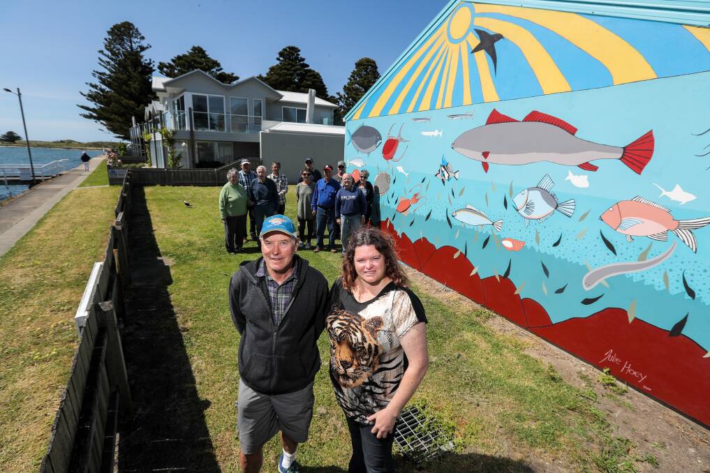 Bright: Port Fairy Angling Club president Barry Starling and members, with artist Julie Hoey who painted the mural on the club's new shed. Picture: Rob Gunstone
