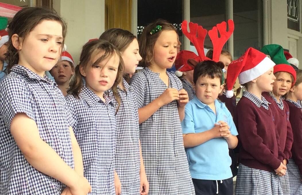 On song: St Patrick's Primary School choir spreads Christmas cheer in Port Fairy on Friday. They will join consolidated school students on Sunday at the town's carols. 