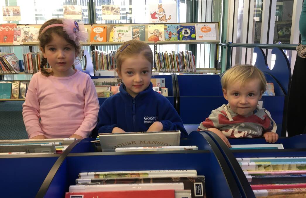 Readers: Bella Goudy, 3, Isabel McGinness, 5, and Peter Nicholls, 2, have read 1000 books each as part of an initiative to encourage families to read more to develop literacy skills. 