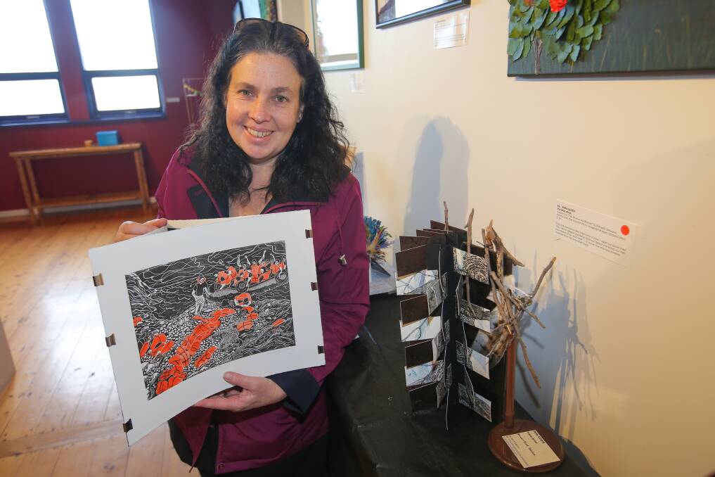 Creative: Jo Canham with one of the Biblio Art competition entries. The Port Fairy exhibition finishes on Friday. Picture: Morgan Hancock