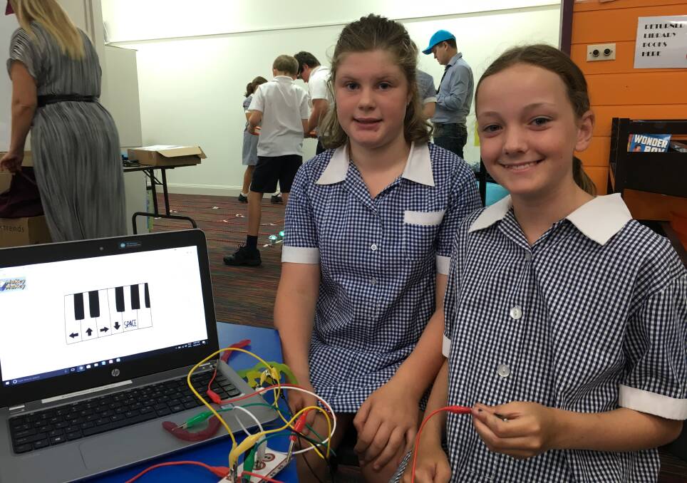New skills: Aliza Gurney, 11 and Matilda Woodward,10, learn about electricity and circuits. Picture: Madeleine McNeil
