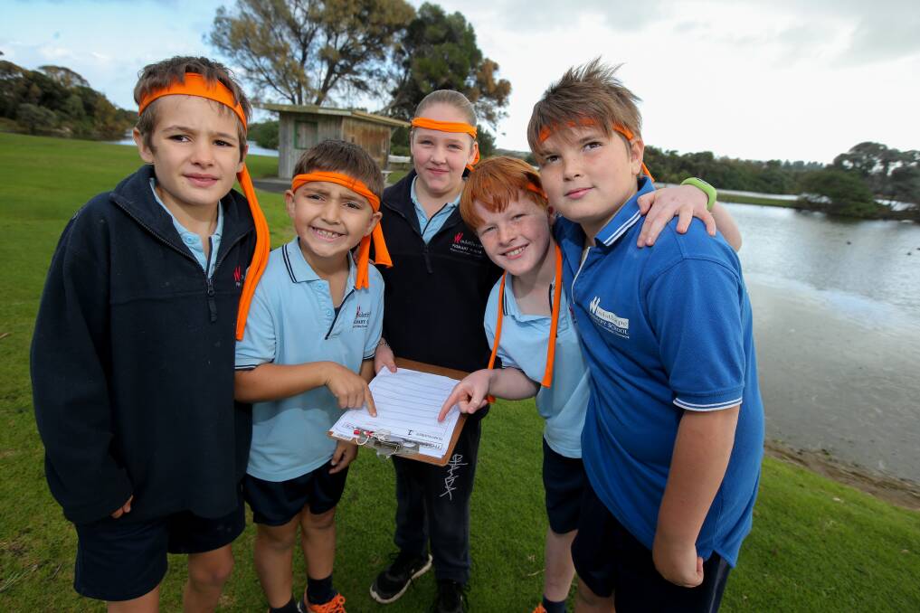 Puzzles: Woolsthorpe Primary School students Josh Banks, 10, Charlie Khourdajian, 8, Phoebe McKenzie, 10, Sam Robinson, 9, and Trey Clarke, 12, check their clues at the Amazing Race on Wednesday. Picture: Rob Gunstone