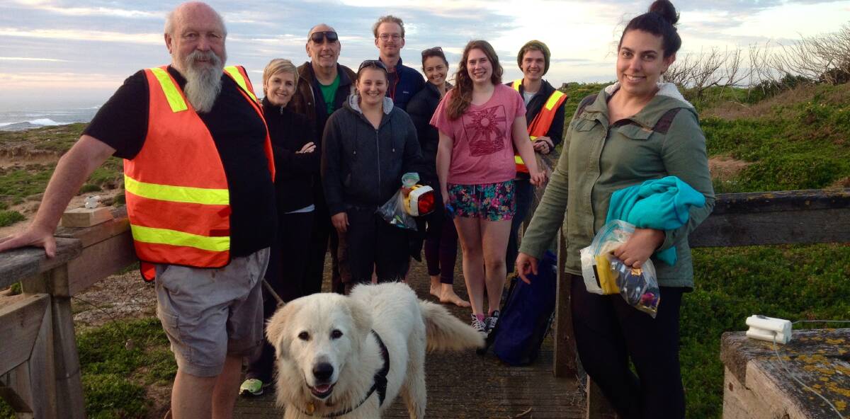 Celebration: Warrnambool Coastcare Landcare Network volunteers and Maremma dog Amor during a penguin count on Middle Island.