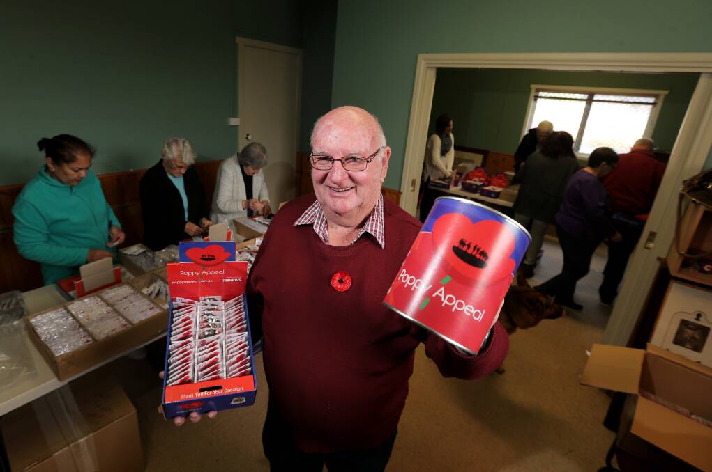 Dedicated: Warrnambool RSL president John Miles and a band of volunteers begin packing Rembrance Day poppies as part of the annual appeal. Picture: Rob Gunstone