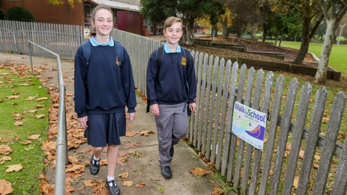Leading by example: St Joseph's Primary School students Caity O'Leary, 11, and Charlie Hughes, 10, put their best foot forward for Walk to School Day on Friday. Picture: Rob Gunstone