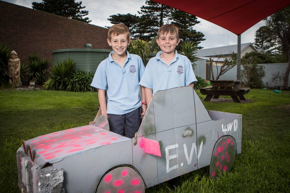 Fast: St Patrick's Parish Primary School Port Fairy students Memphis Bant and Eamon West with the cardboard car they will race on Sunday.