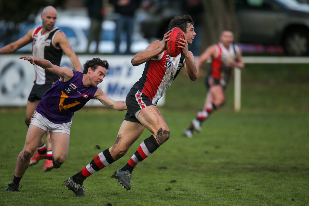CATCH US IF YOU CAN: Koroit ruckman Jeremy Hausler got away from Port Fairy's Cam Pevitt on Saturday. Picture: Rob Gunstone