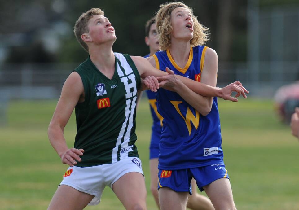 EYES ON THE BALL: Hampden's Josh Worboys and Wimmera's Riley Bryan contest a ruck contest during their schoolboys match in Ararat.