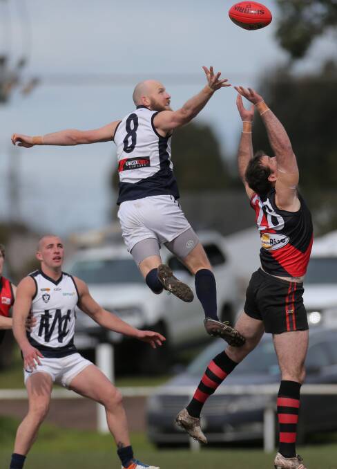 TALL TIMBER: Opposing ruckmen - Warrnambool's Daniel Weymouth and Cobden's Levi Dare - contest the ball on Saturday. Picture: Vicky Hughson