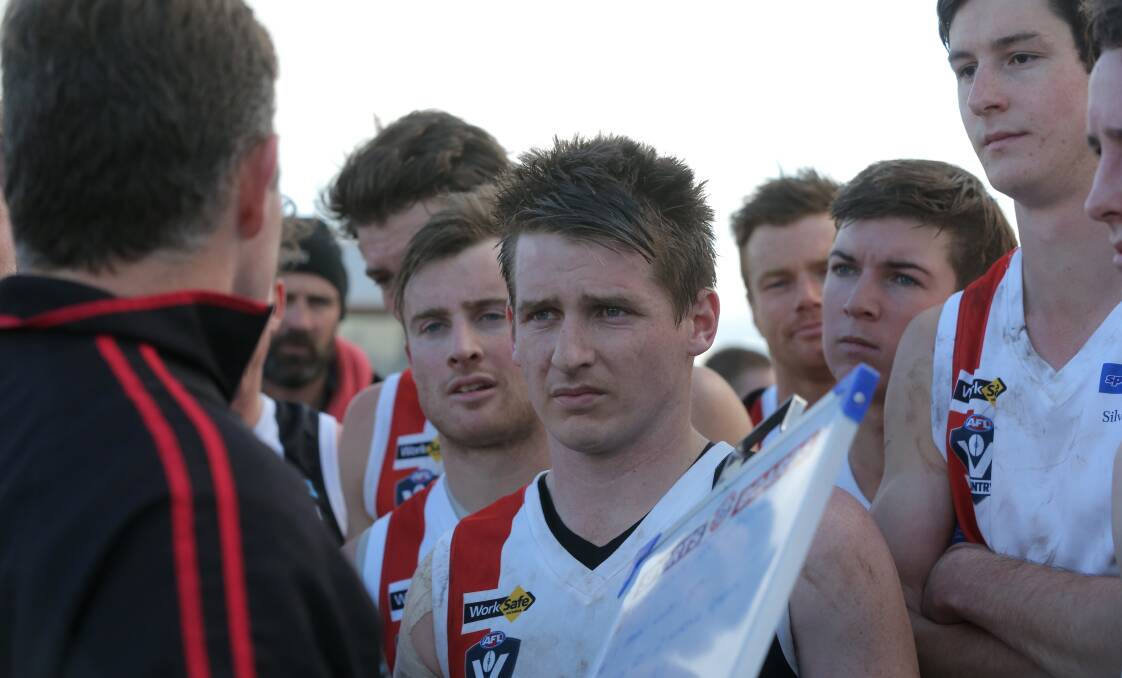 MOVING THE MAGNETS: Koroit midfielder Ben Walsh listens to Saints coach Adam Dowie hand out instructions in the break. Picture: Vicky Hughson