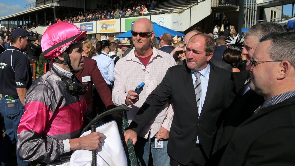 HAPPY CHAPPIES: Rata Tat Tat jockey Steven Arnold talks to the winner's connections after winning a two-year-old handicap on Thursday. Picture: Rob Gunstone