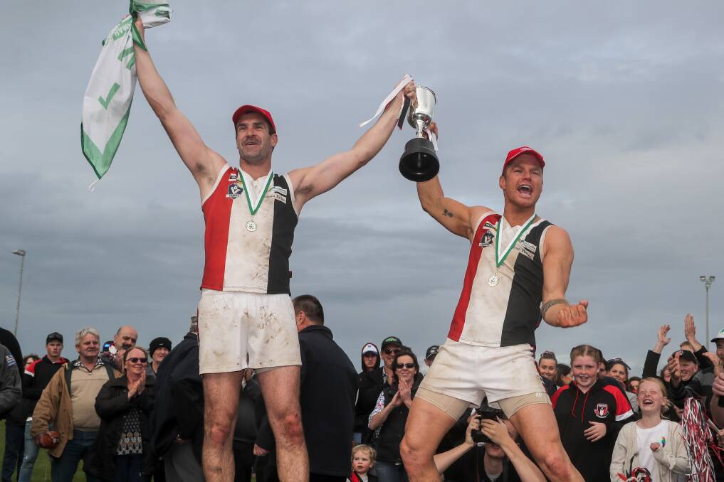 PLAYING HURT: Koroit skipper Isaac Templeton (right) celebrated the Saints' fourth straight flag in September alongside coach Chris McLaren. Templeton carried a serious hamstring injury into the game. Picture: Rob Gunstone