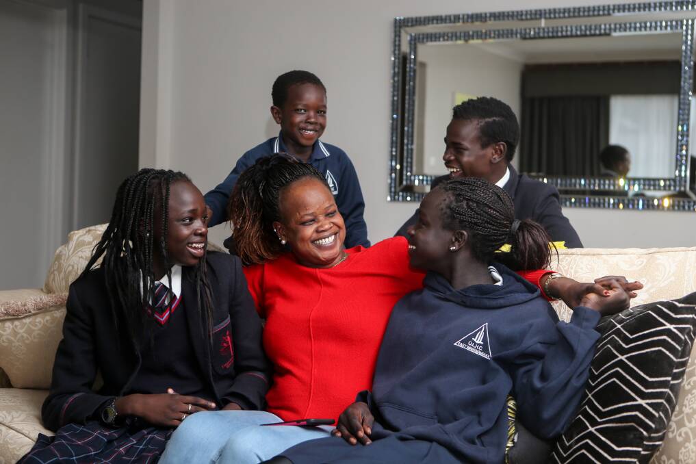 HAPPY: Sudan-born Teresa Padiet and her children Daniella Ajang, 14, Evans Ajang, 5, Emmanuel Ajang, 15, and Ywomo Ajang, 11, love living in Australia. Picture: Amy Paton