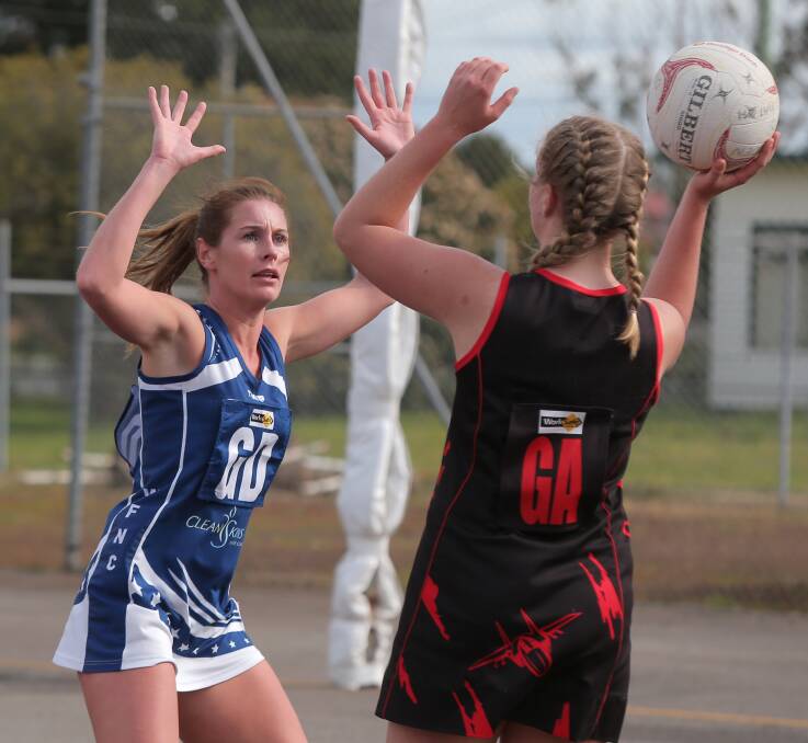 HAND UP WHO WANTS TO PLAY FINALS: Warrnambool's Jenna Graham and Cobden's Molly Hutt in action during their must-win final-round clash. The Bombers took the spoils - and a top-five berth. Pictures: Vicky Hughson