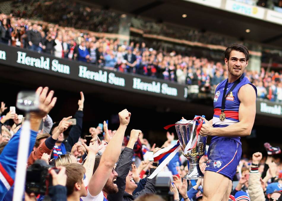 LEADER OF THE PACK: Western Bulldogs captain Easton Wood celebrates their drought-breaking premiership with fans at the MCG. Picture: Getty Images