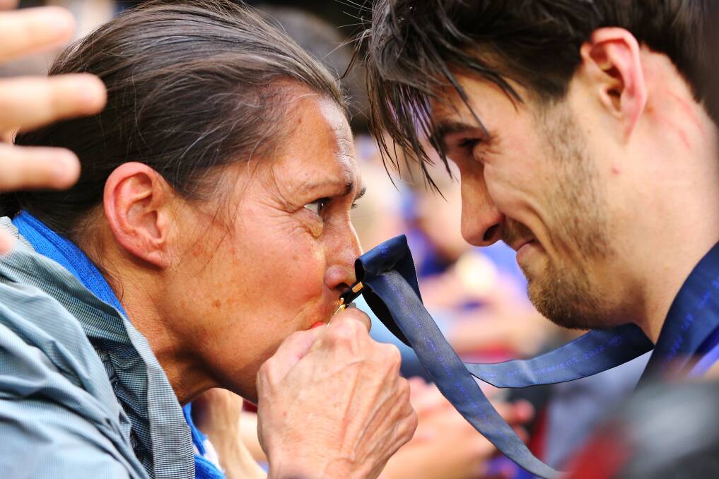 PROUD PARENT: Easton Wood's mum Fiona, who lives in Gnotuk, kisses his premiership medal. Picture: Getty Images