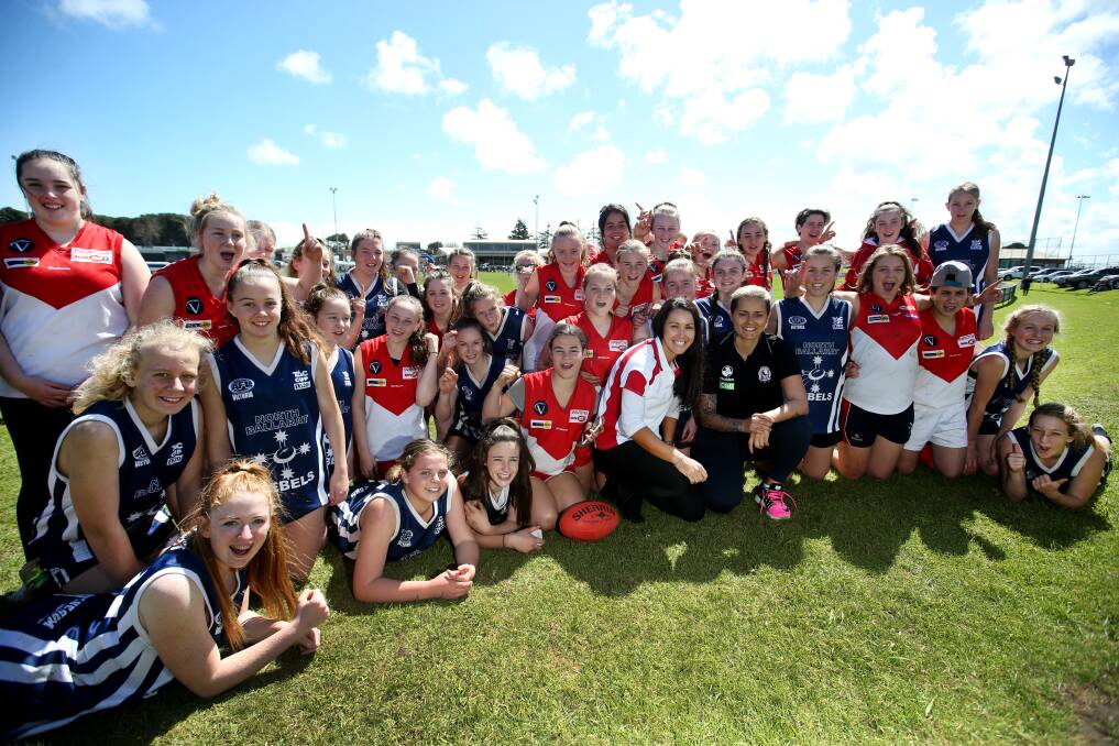 INSPIRATION: Elite female footballers, Darebin Falcons' Nicky Callinan and Collingwood's Moana Hope, with south-west players in Warrnambool on Friday. Picture: Amy Paton