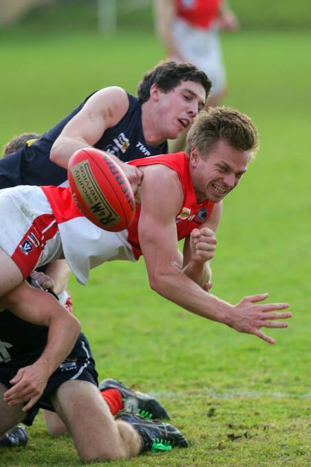 CRUNCH: Warrnambool's Jackson Bell collects South Warrnambool's Zacc Struth in a tackle at Reid Oval on Saturday. Picture: Rob Gunstone
