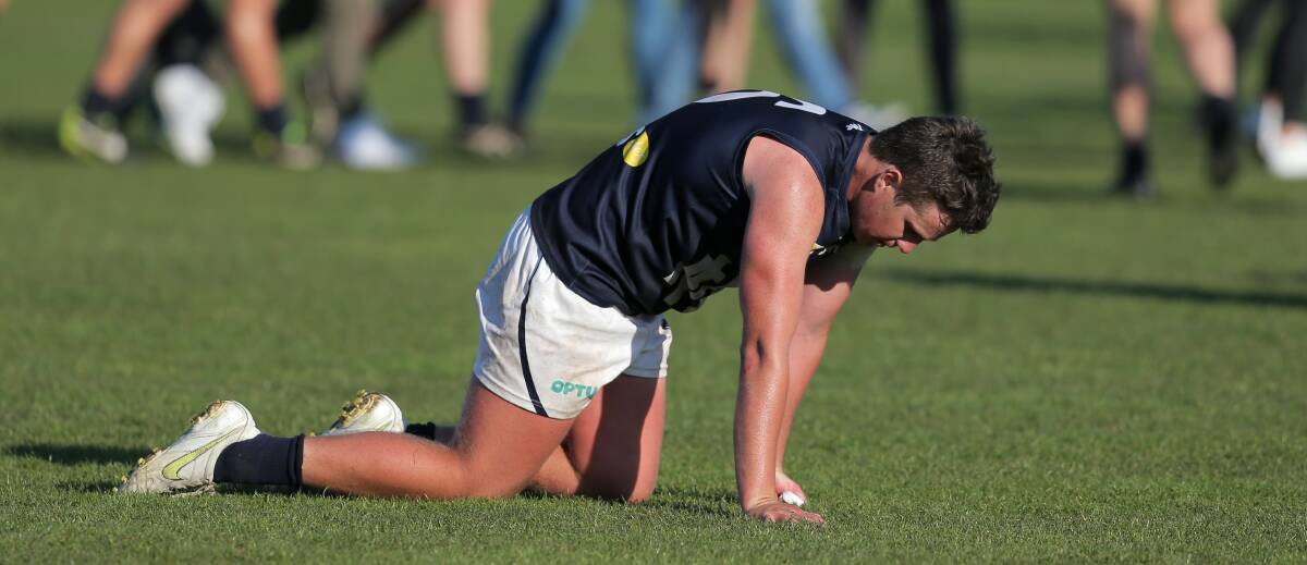 ADMIRABLE: Warrnambool defender Liam Hoy slumps to his hands and knees after the final siren. Hoy was among the Blues' best in the grand final. Picture: Rob Gunstone