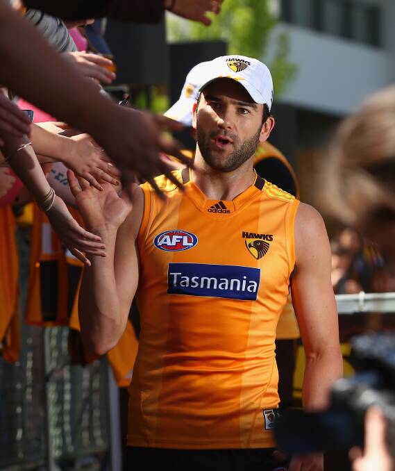 READY TO GO: Hawthorn onballer Jordan Lewis high-fives fans during the Hawks' final training session before the AFL grand final. Lewis is hoping to add a fourth premiership medal to his collection. Picture: Getty Images