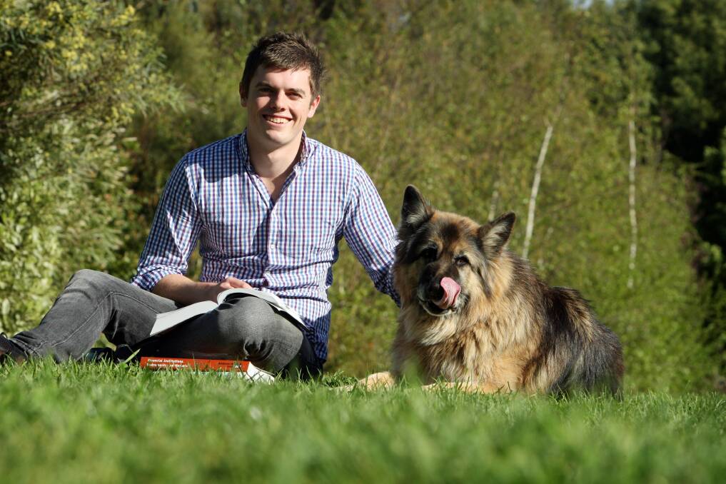 ROAD TO RECOVERY: Mr Hulin hits the books with his dog Moritz back in 2011. He studied at Deakin in Warrnambool.