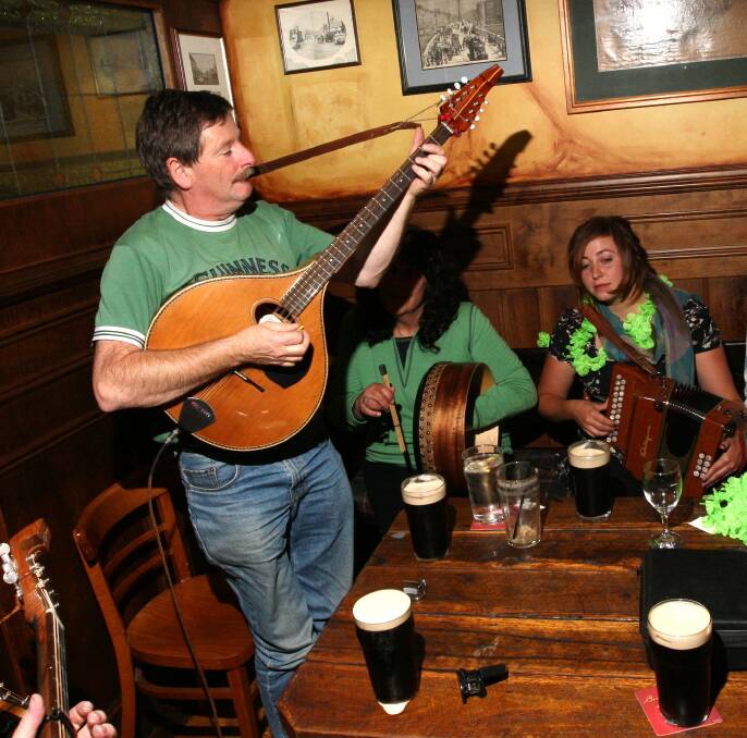 LIFE OF THE PARTY: Tommy Carty (standing) leads a St. Patrick's Day session at The Seanchai in Warrnambool in 2013. A session in his honour is planned this Saturday. 