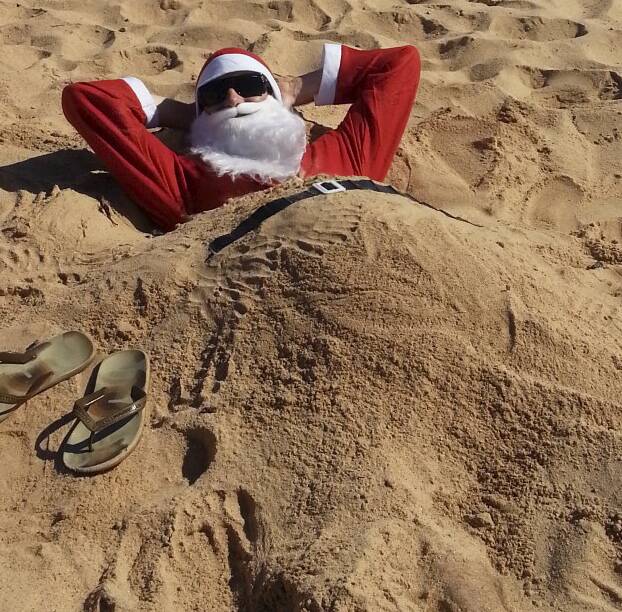 Slip, slop, slap Santa: C'mon Santa, there's no time to lie around on Port Fairy's East Beach. It's almost Christmas and you've got millions of presents to deliver.