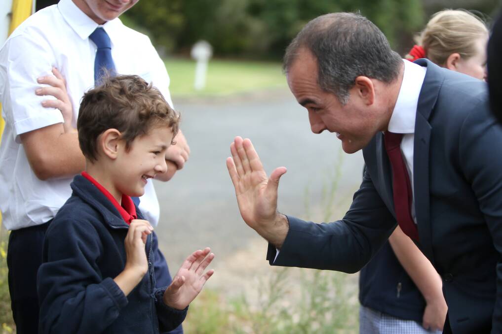 Minister for Education James Merlino (centre) announces new site on Wollaston Rd for Warrnambool Special Development School. Pictured: Minister James Merlino highfives student Max Darmanin, 6. Picture: Amy Paton