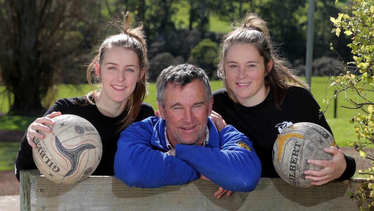 NEW COLOURS: Jaymie (left) and Emily Finch (right), pictured here with their father, have traded Camperdown black and white for Cobden red and black this season. Picture: Rob Gunstone