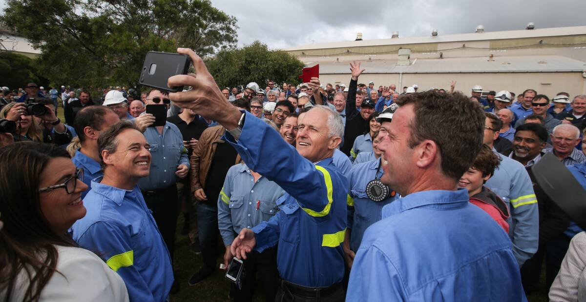 Capture the moment: Prime Minister Malcolm Turnbull takes a selfie with a smelter worker, surrounded by a sea of jubilant Alcoa employees. Picture: Amy Paton