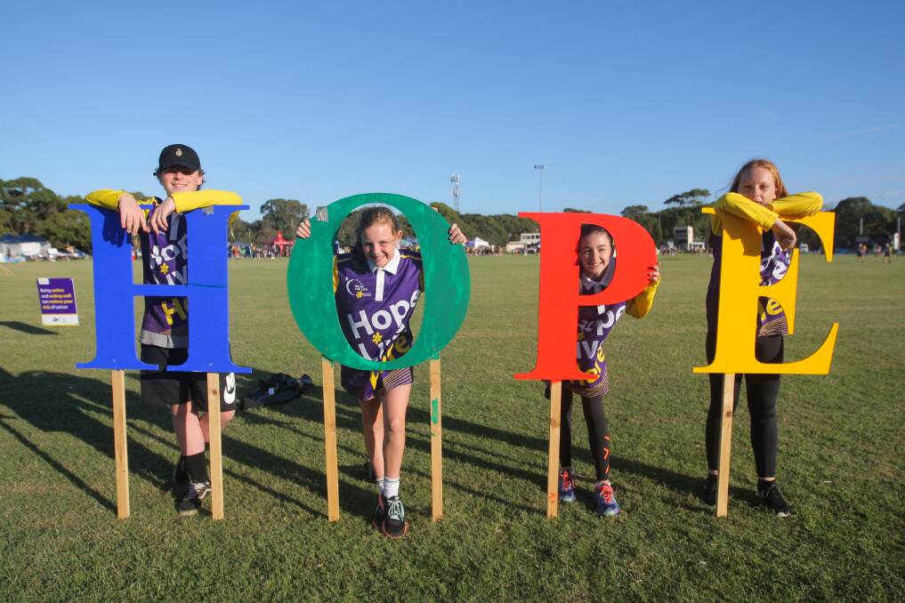 Strong message: Riley Harper, 14, Tara Crispe, 12, Charli Forsyth, 12 and Amanda Dwyer of Warrnambool during the annual Relay for Life, raising money for the Cancer Council. Picture: Morgan Hancock