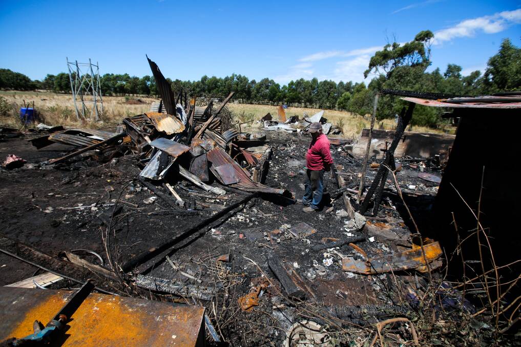 RUINS: Steve Fowler looks at the site of a shed fire on his Garvoc farm property on Sunday. Picture: Rob Gunstone